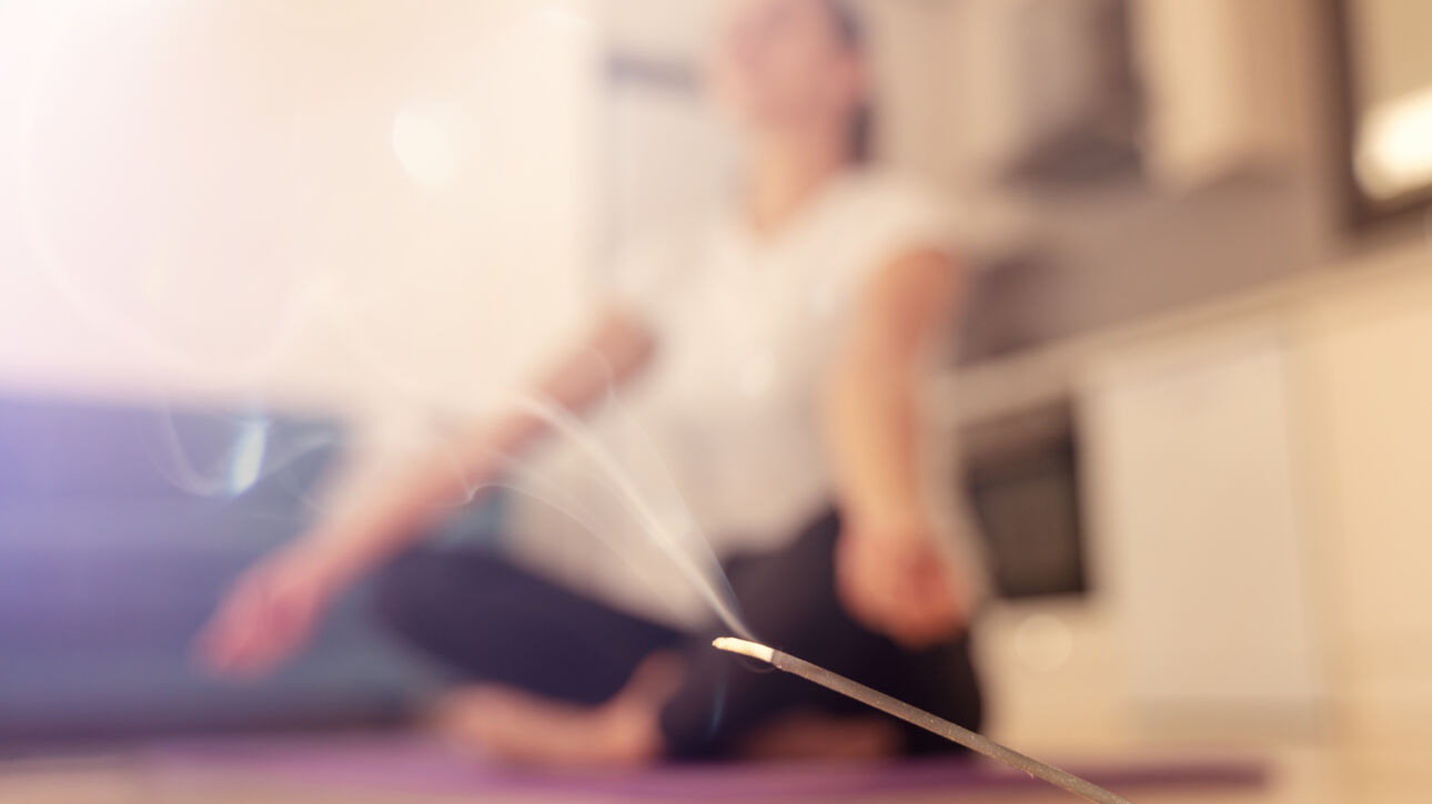 burning aroma stick and woman meditating doing yog 2026 01 06 00 51 36 utc